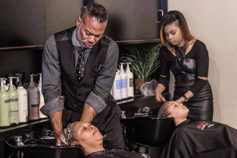 hairstylists washing clients' hair