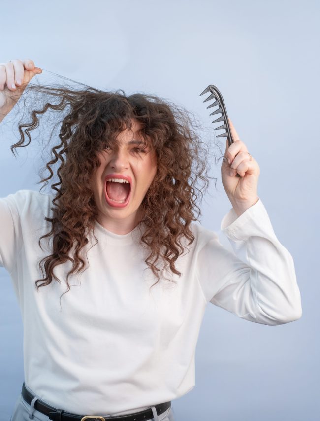 249661124_m Curly hair tangles badly causing painful discomfort while brushing